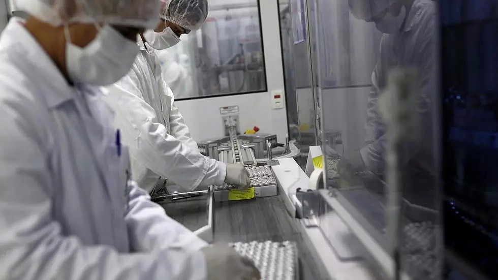 2021年1月12日，巴西圣保罗Butantan生物医学研究生产中心的工作人员正在向瓶子里灌装科兴疫苗试剂。