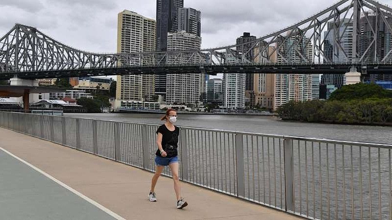 a-person-walking-across-a-bridge-victorians-in-brisbane-are-now-able-to-come-home-since-the-covid-19_833700_.jpg,0