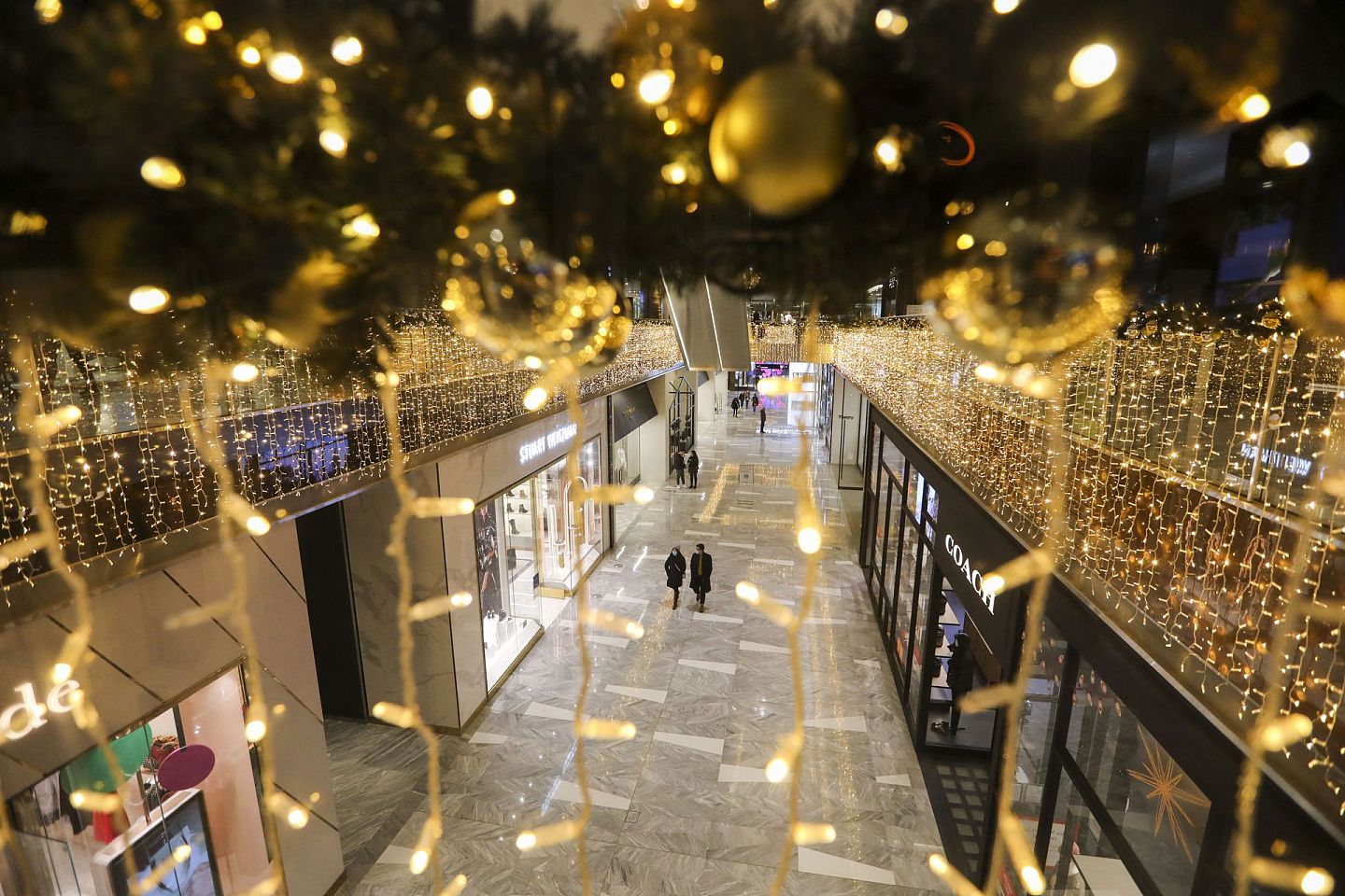 12月22日，纽约一家装饰一新的购物中心内顾客寥寥。（新华社）