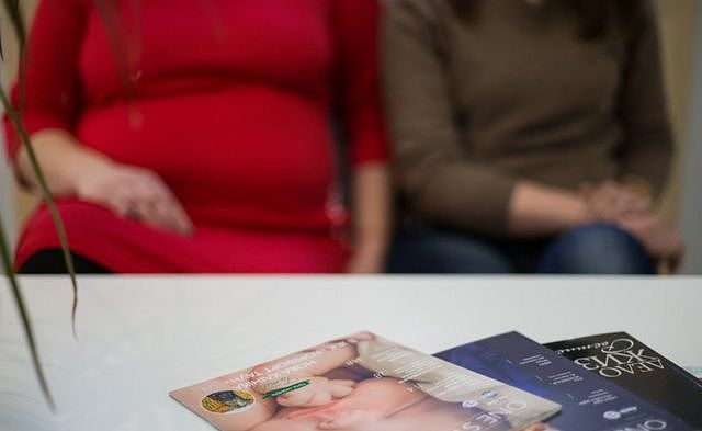 Two surrogates sitting in a waiting room