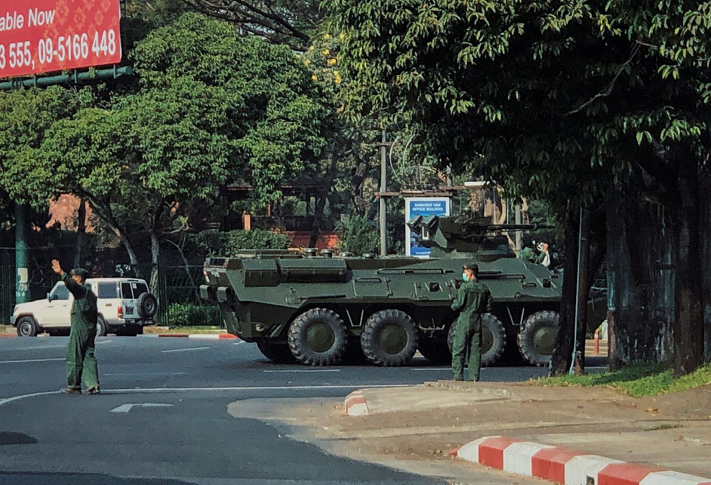 2021年1月28日，一辆装甲运兵车在缅甸仰光道路上行驶，士兵们正在清理交通。（Reuters）