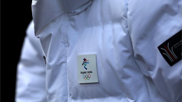 The emblem of the Beijing 2022 Winter Olympic Games is seen on the coat of a staff member during an organised media tour to Beijing Winter Olympic and Paralympic Village in Beijing, China January 22, 2021.