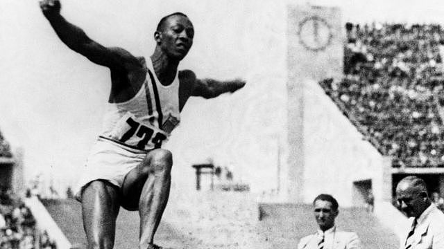 Berlin, Germany : Jesse Owens of the United States leaps to gold and sets a world record in the running board jump, at the 1936 Olympic Games