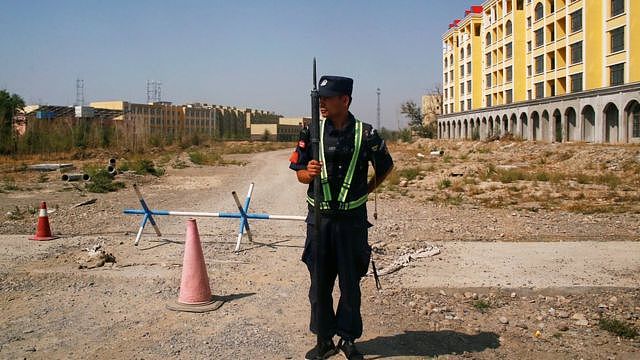 Chinese police officer outside what is formally known as a 