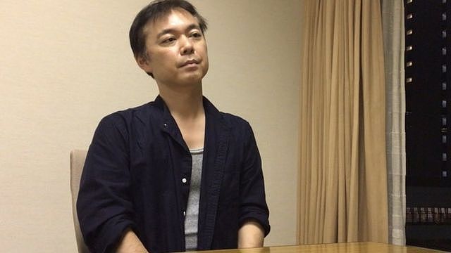 A 2020 picture of Koichiro Iizuka sitting in a conference room in Tokyo