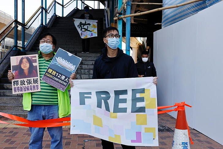 Two pro-democracy supporters protesting to urge for the release of journalist Zhang Zhan.