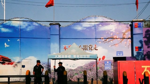 Security guards stand at the gates of what is officially known as a vocational skills education centre in Huocheng County in Xinjiang Uighur Autonomous Region, China September 3, 2018