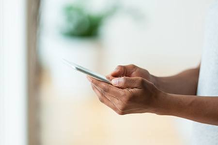 51547392-african-american-person-holding-a-tactile-mobile-smartphone-black-people.jpg,0