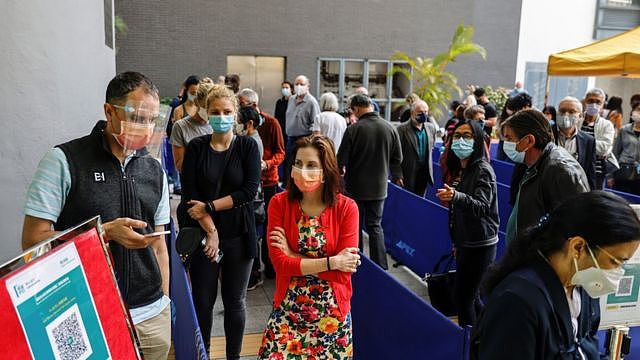 People queue up at a vaccination centre after Hong Kong temporarily suspended coronavirus disease (COVID-19) vaccine from a single batch of Pfizer/BioNTech shots due to packaging defects, in Hong Kong, China March 24, 2021.