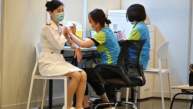 A health care worker is given a COVID-19 vaccination at a clinic in Hong Kong, China, 23 February 2021.