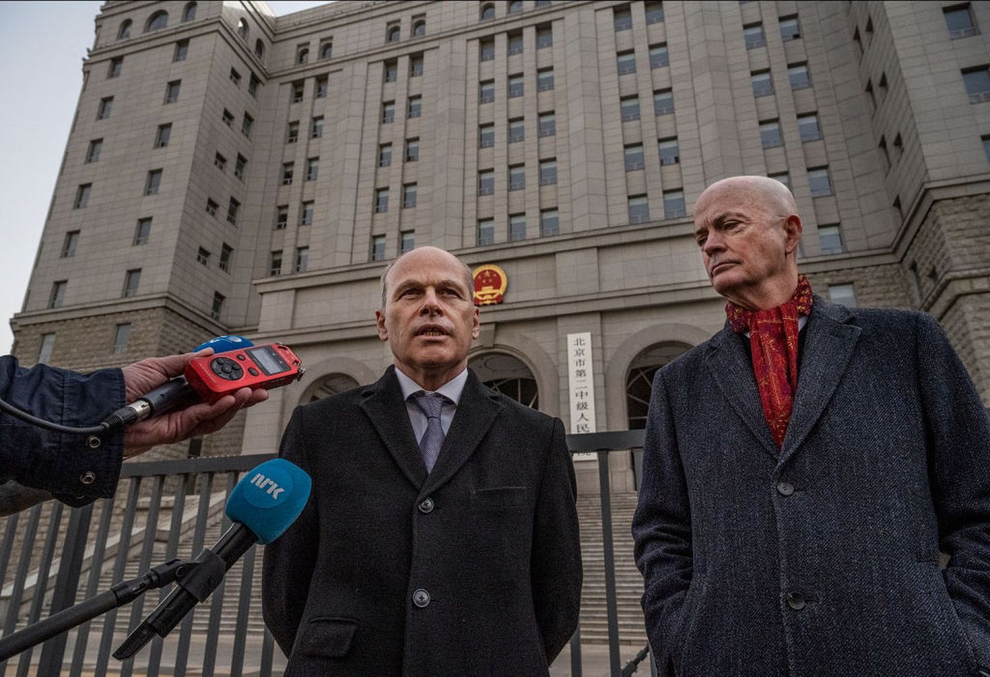 图为2021年3月22日，加拿大驻中国临时代办倪杰民（左）于北京的法院外面会见媒体。（Getty）