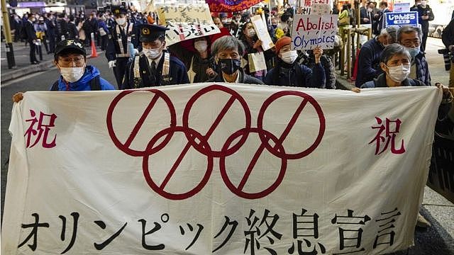 Demonstrators march though Shimbashi streets to protest against the start of torch relay of the Tokyo 2020 Olympic Games in Tokyo, Japan, 25 March 2021 after the torch relay of the Olympics started in Fukushima, northern Japan. Demonstrators shouted 