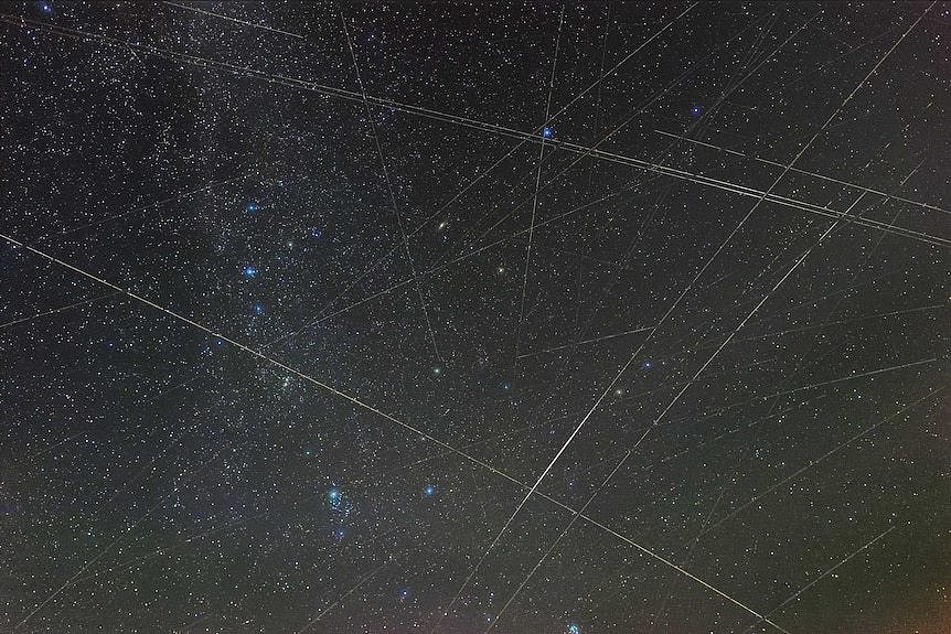 An image of the Perseids meteor shower with lines made by satellites.