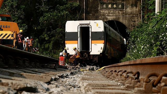 Rescuers remove parts of the train which derailed in a tunnel north of Hualien County, eastern Taiwan, 03 April 2021. According to news reports 51 people died and many others were injured when a train carrying 490 people derailed in a tunnel north of Hualien in eastern Taiwan on 02 April.