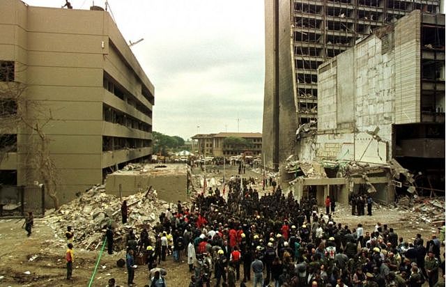 Crowds gather at a memorial ceremony held at the scene of the bombing of the U.S. Embassy building in Nairobi, Kenya on August 12, 1998