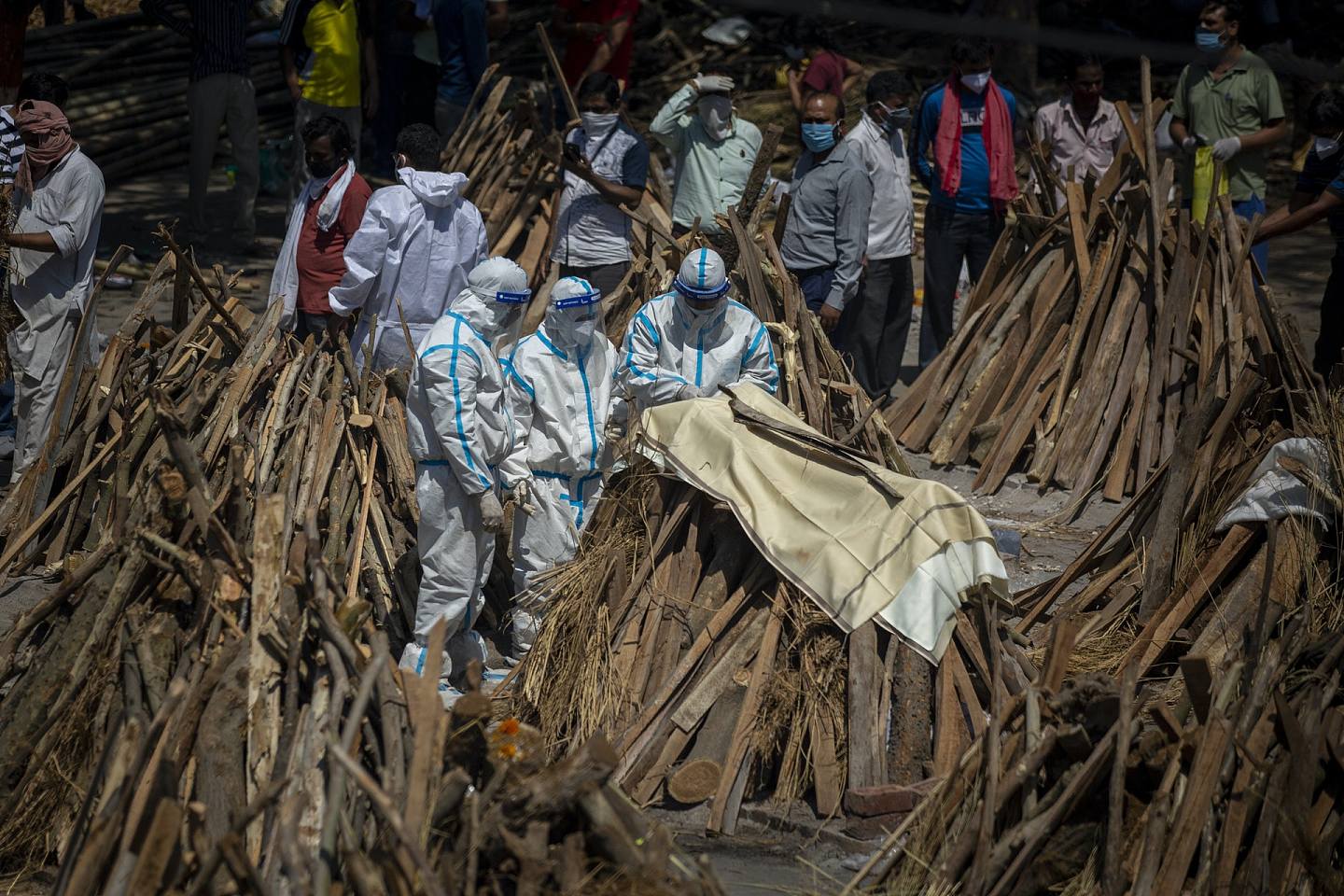 印度防疫人员将死者遗体放在柴火堆上。 （AP）