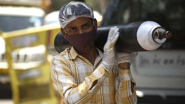 A person waiting outside an oxygen-filling centre to refill their empty cylinder at Sector-14, IDC colony near Maharana Pratap Chowk, on April 26, 2021 in Gurgaon, India.