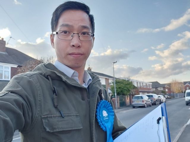 Timothy Cho takes a selfie wearing a Conservative Party rosette