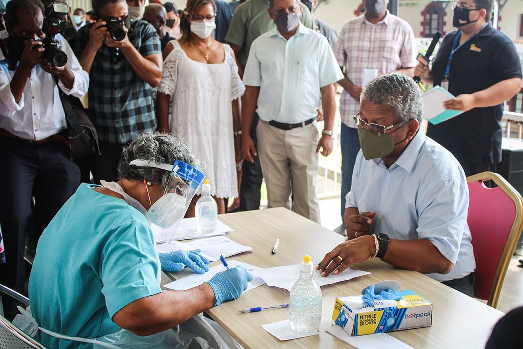 塞舌尔总统瓦韦尔·拉姆卡拉旺（右）今年1月接种第一剂中国国药集团疫苗前填写有关表格。他为本国的疫苗接种计划进行了辩护。