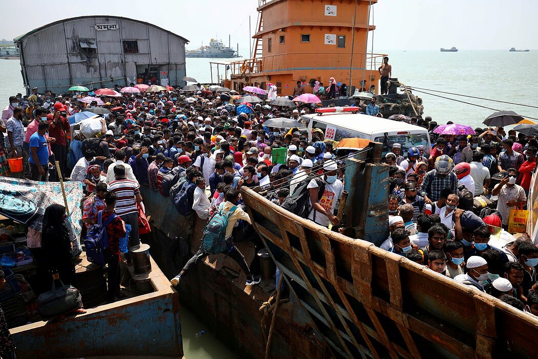 孟加拉国蒙希甘杰的移民拥挤着登上渡轮，回家过开斋节。