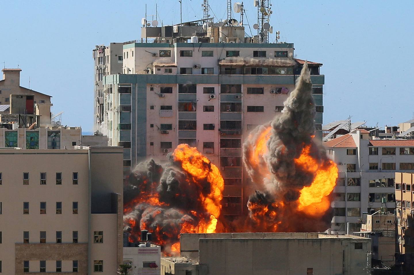 以巴冲突：图为5月15日以色列战机炸毁位于加沙地带的Al-Jalaa大楼后，大楼冒出浓烟和火焰。 （Reuters）