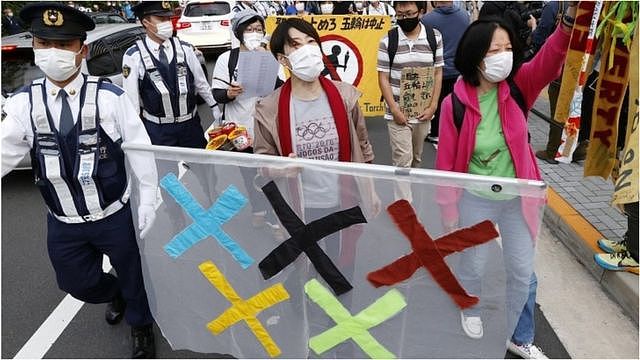 People protest in Tokyo against holding the 2020 Olympics amid the coronavirus pandemic