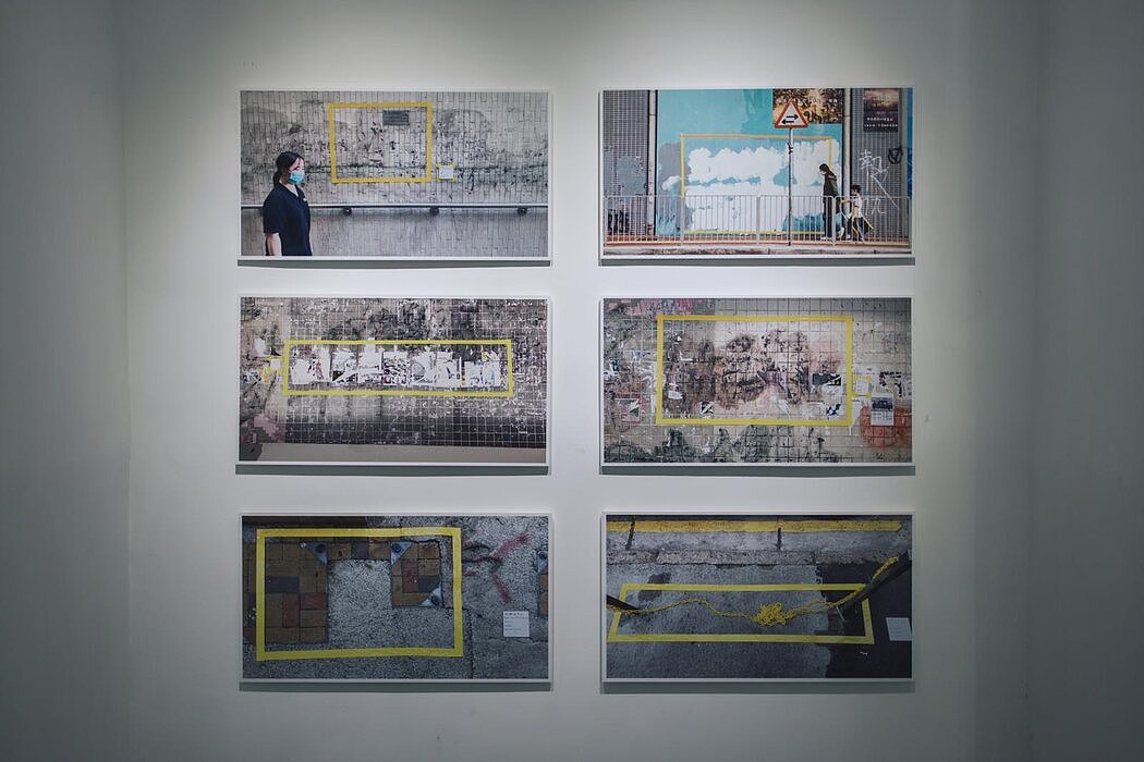 梁洛熙用黄色胶带框住当局抹去反政府涂鸦的墙壁。