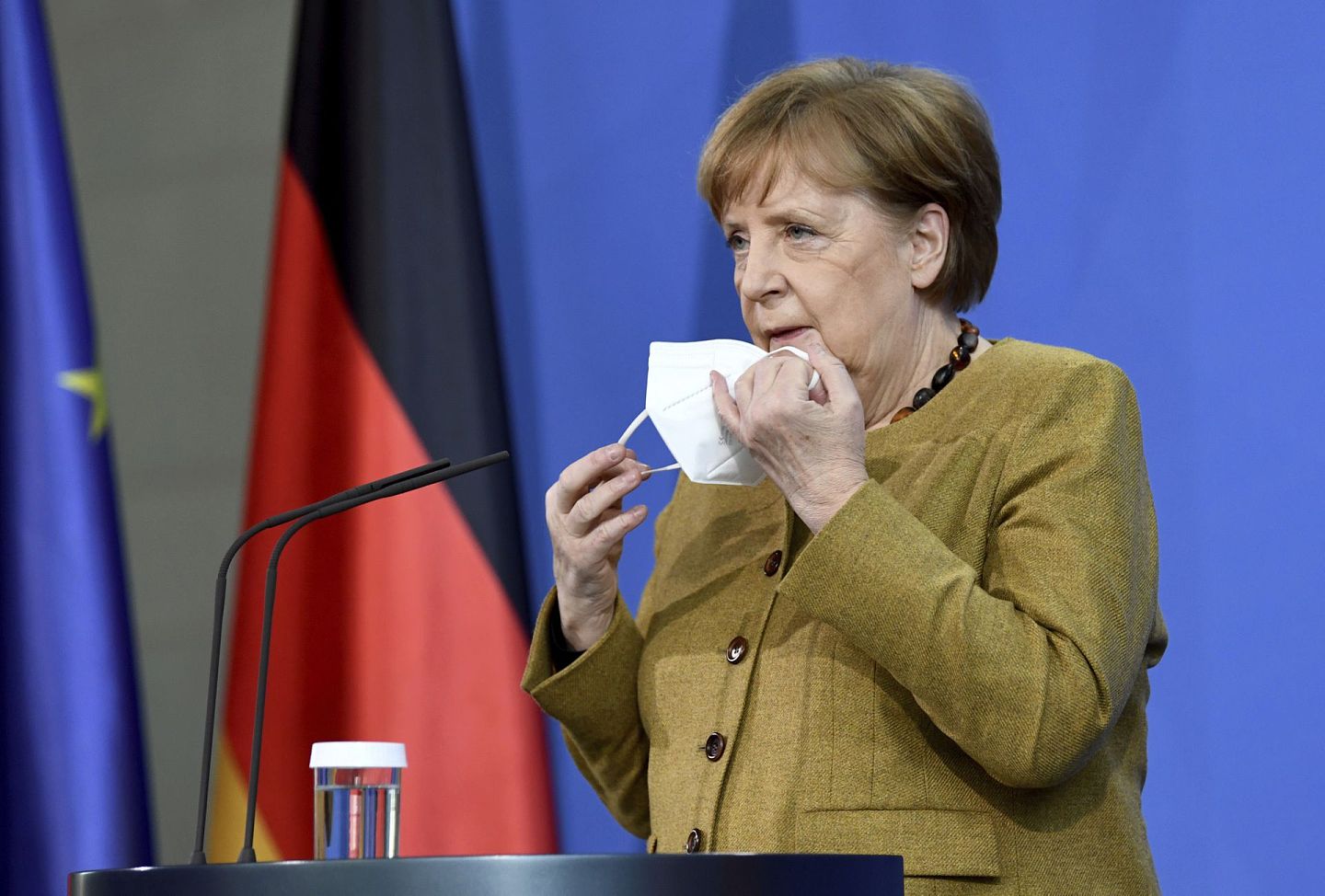 媒体披露，德国总理默克尔长期遭美国国家安全局监视。图为2021年2月19日，默克尔摘下口罩准备发表演讲。（AP）