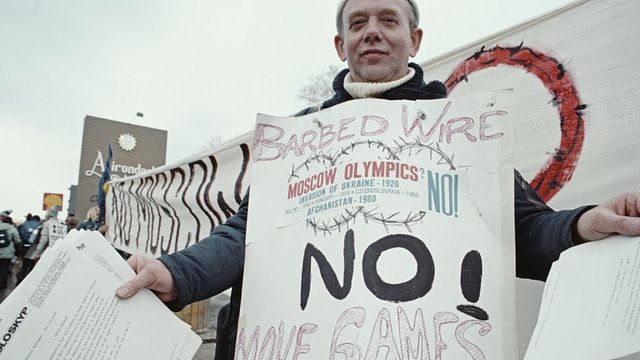 A protester against the Moscow summer Olympics boycott during the Opening Ceremony for the XIII Olympic Winter Games on 14 February 1980 at the Lake Placid Equestrian Stadium, Lake Placid, United States. (Photo by Steve Powell/Allsport/Getty Images)