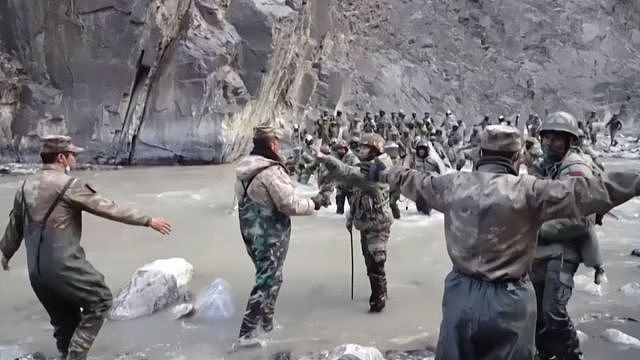 This video frame grab taken from footage recorded in mid-June 2020 and released by China Central Television (CCTV) on February 20, 2021 shows Chinese (foreground) and Indian soldiers (R, background) during an incident where troops from both countries clashed