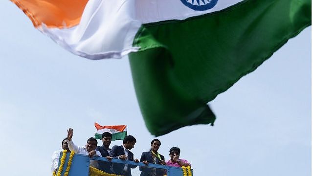 Indian badminton player and Olympic silver medalist P.V Sindhu (2R) and her coach P. Gopichand (C) take part in a parade after arriving home from the Rio Olympics in Hyderabad on August 22, 2016. India swelled with pride August 20 after badminton champion P.V. Sindhu became the first woman in the country's history to win an Olympic silver medal. /