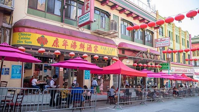 People eat outside a restaurant in San Francisco's Chinatown