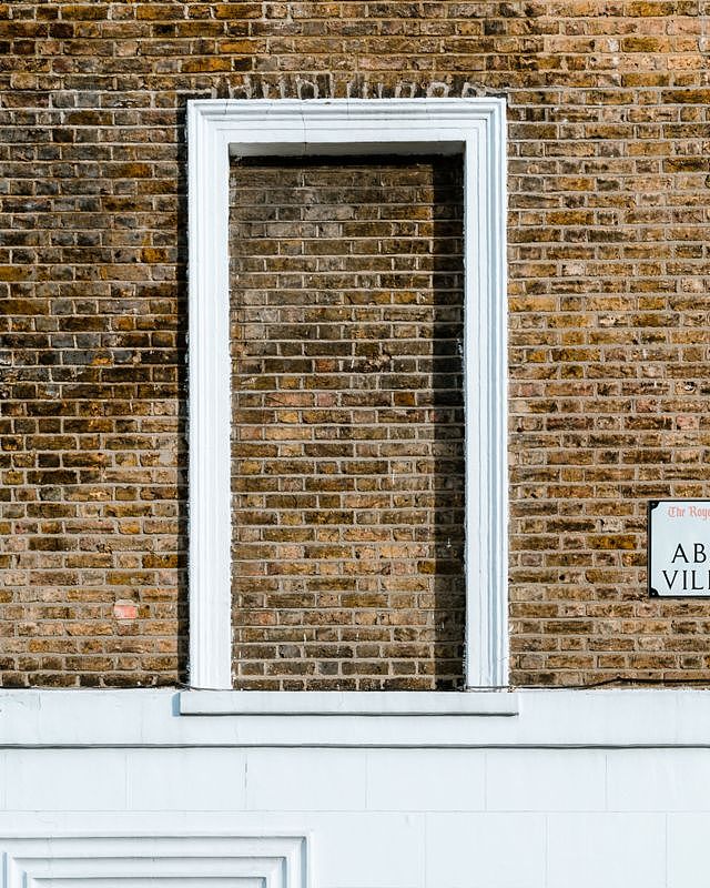 Brick wall with a single blocked window, on Abingdon Villas, London