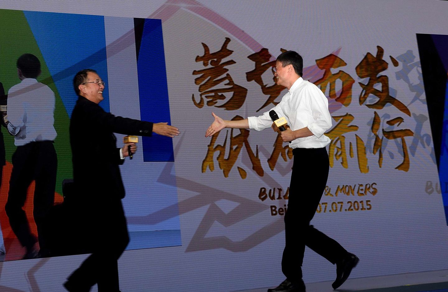 2015年7月7日，联想控股创始人柳传志（左）在主题活动上与阿里巴巴集团董事局主席马云握手。（新华社）