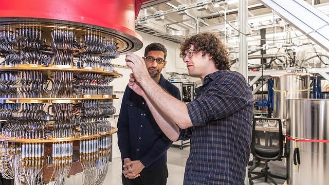 Senior research scientist, Daniel Sank, shows Sundar Pichai one of the quantum computers in the Santa Barbara lab