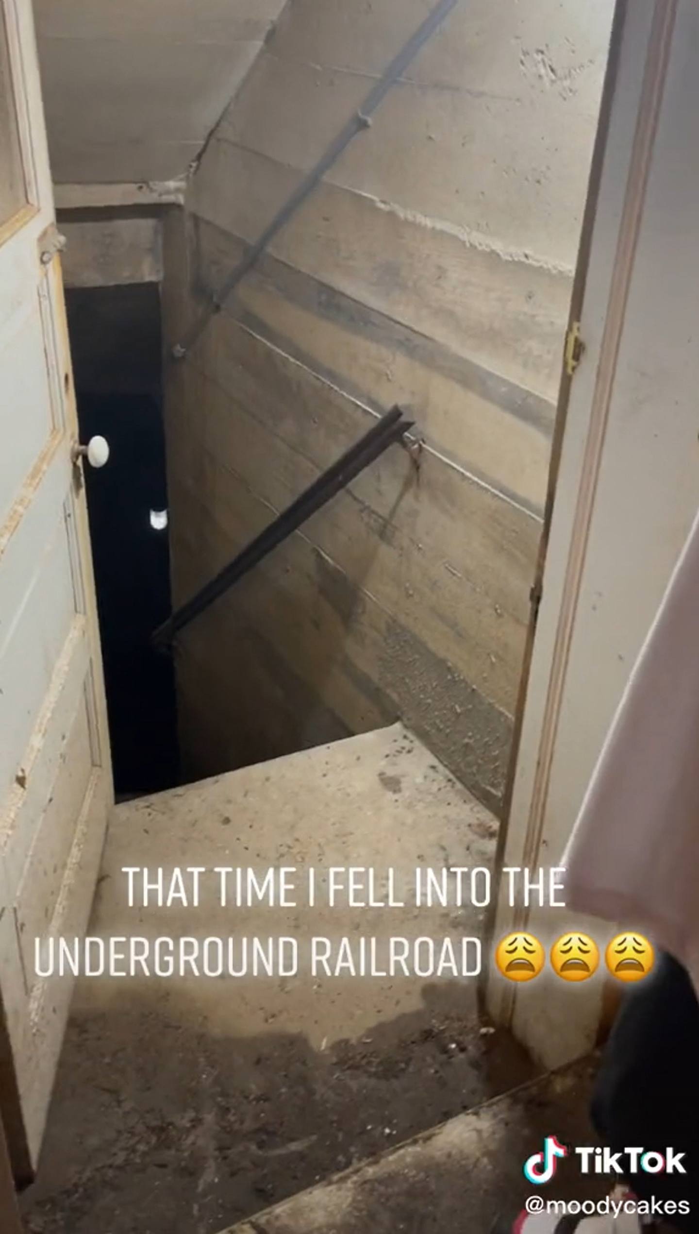 美国一名网民在家中意外发现1道神秘楼梯，可通往地下30尺，因而带着表妹一同出发展开「地底探险」，（TikTok「moodycakes」截图）
