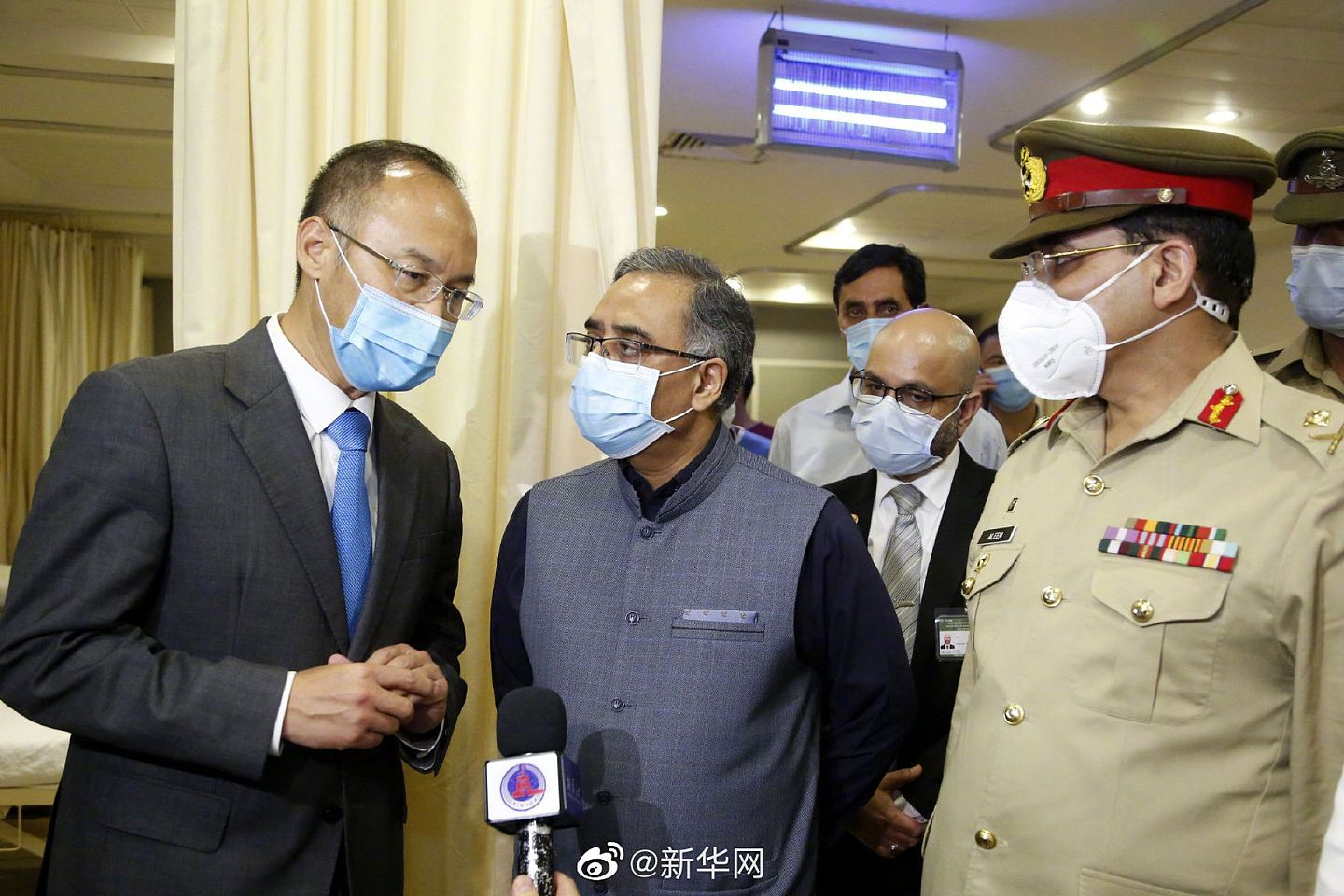 中国驻巴基斯坦大使农融（左一）赴医院看望部分受伤同胞。巴外交秘书苏海尔·马哈茂德陪同看望。（微博@新华网）