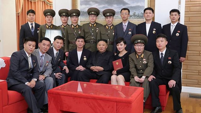 A photo released by the official North Korean Central News Agency (KCNA) on 12 July 2021 shows North Korean leader Kim Jong-Un (front C) meeting and congratulating creators and artistes of major art troupes who have received state commendations in Pyongyang, North Korea, 11 July 2021.