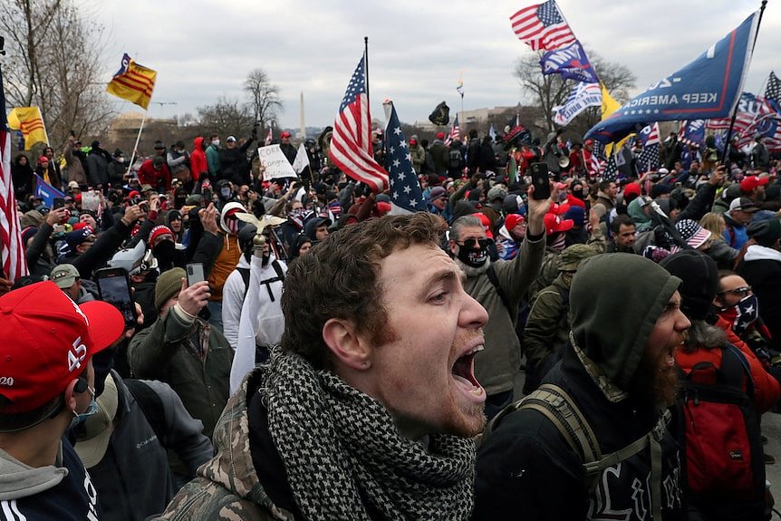 Close up of face of man shouting in a crowd of pro-Trump rioters at the US Capitol in Washington