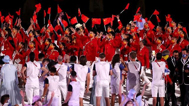 Members of Team China wave flags during the Opening Ceremony of the Tokyo 2020 Olympic Games at Olympic Stadium on July 23, 2021 in Tokyo, Japan.
