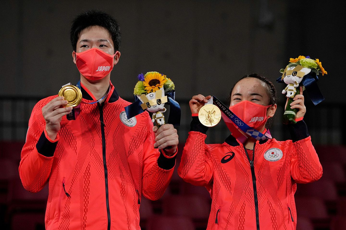日本选手展示首枚奥运混双金牌。（AP）