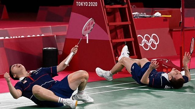 Malaysia's Soh Wooi Yik and Aaron Chia (left) celebrate as they win their men's doubles badminton bronze medal match at Tokyo 2020 Olympic Games