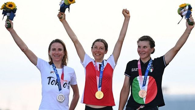 Austria cyclist Anna Kiesenhofer (centre), a scientist and Olympic champion