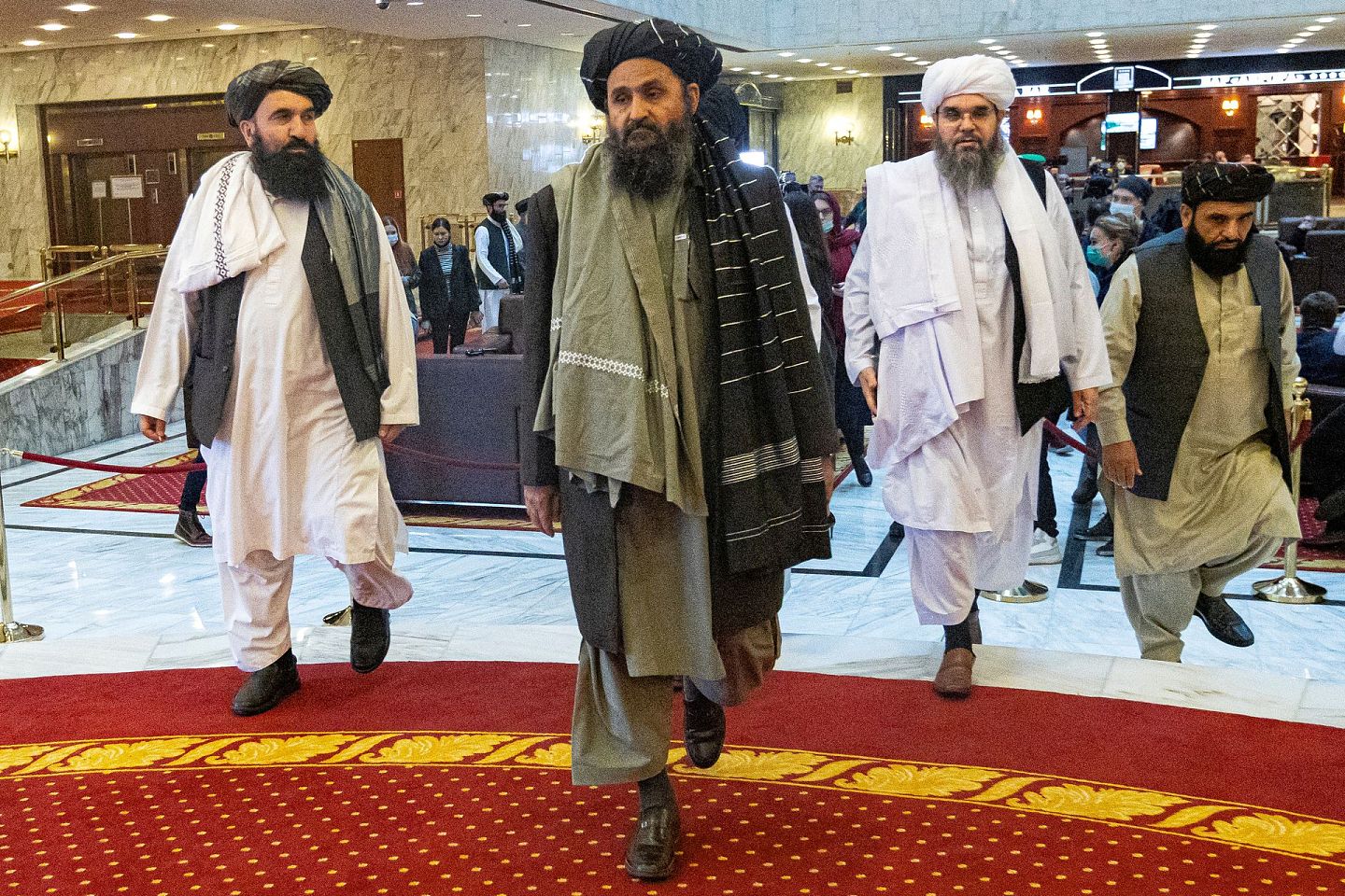 图为2021年3月18日，阿富汗塔利班副领袖、首席谈判代表巴拉达尔（Mullah Baradar，中）及代表团成员抵达俄罗斯莫斯科出席和谈。（Reuters）