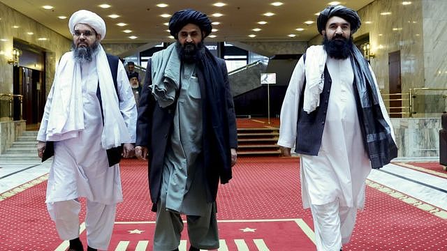 Taliban delegation headed by Abdul Ghani Baradar (C), the groups deputy leader, are seen leaving the hotel after attending the meeting on Afghan peace with the participation of delegations from Russia, China, the US, Pakistan in March 2021