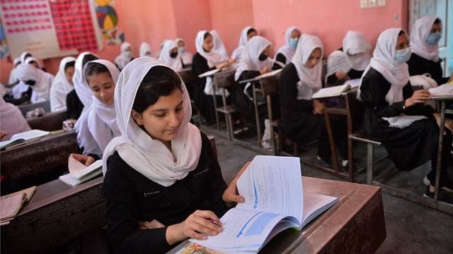 Girls sitting at desks reading