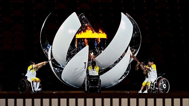 The Paralympic flame is lit by, from left, Shunsuke Uchida, Yui Kamiji and Karin Morisaki during the Opening Ceremony of the Tokyo 2020 Paralympic Games at the Olympic Stadium in Tokyo, Japan.