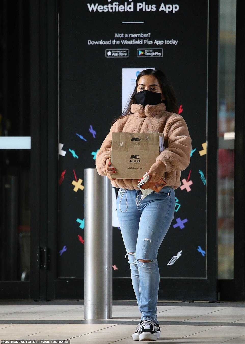 A woman leaves Westfield Eastgardens - one of NSW's biggest Westfield's - with click-and-collect goods on Wednesday (pictured)