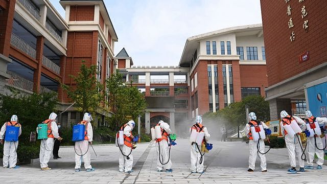 Workers disinfect primary school in Wuhan on 25 August 2021. Photo Barcroft Media
