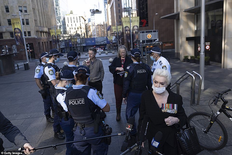 Police speak to a group of protesters that gathered together in Martin Place in Sydney on Tuesday